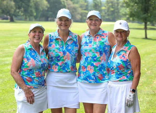 Team photo of golfers in matching outfits